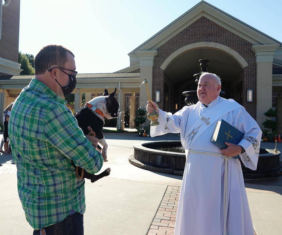 HUNTERSVILLE — Deacon Tom McGahey blessed parishioners — and their pets — at the annual Blessing of the Pets held in honor of St. Francis of Assisi on Oct. 3. (Photos provided by Amy Burger)