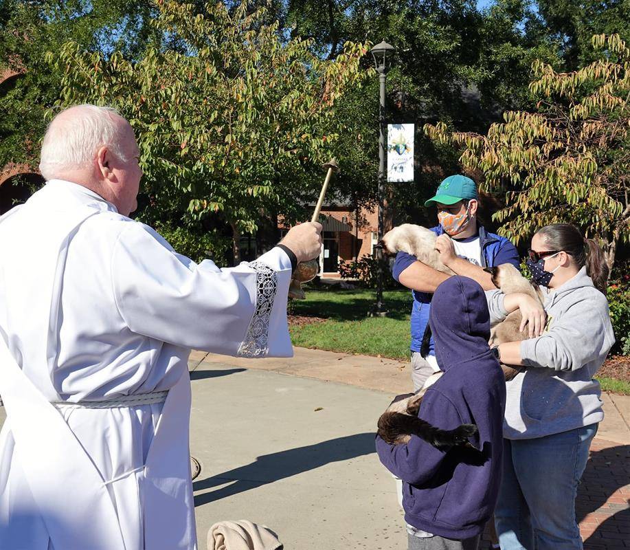 HUNTERSVILLE — Deacon Tom McGahey blessed parishioners — and their pets — at the annual Blessing of the Pets held in honor of St. Francis of Assisi on Oct. 3. (Photos provided by Amy Burger)