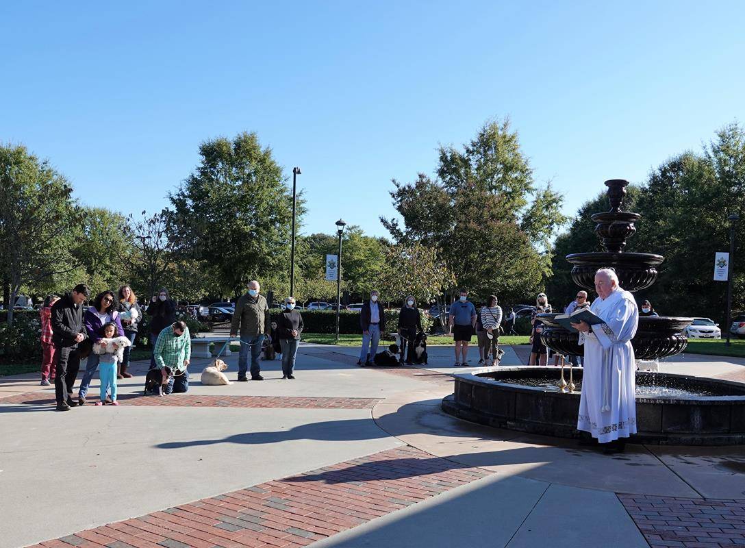 HUNTERSVILLE — Deacon Tom McGahey blessed parishioners — and their pets — at the annual Blessing of the Pets held in honor of St. Francis of Assisi on Oct. 3. (Photos provided by Amy Burger)