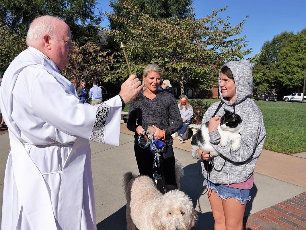 HUNTERSVILLE — Deacon Tom McGahey blessed parishioners — and their pets — at the annual Blessing of the Pets held in honor of St. Francis of Assisi on Oct. 3. (Photos provided by Amy Burger)