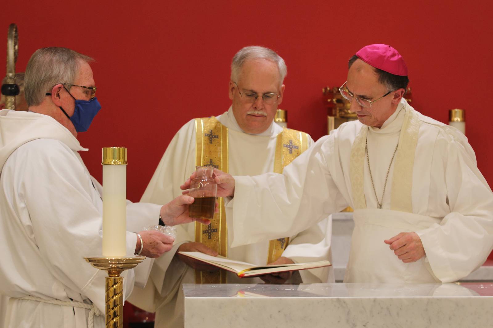 Bishop Peter Jugis prepares to bless the new altar with sacred oil in the Holy Family Chapel on Jan. 27.