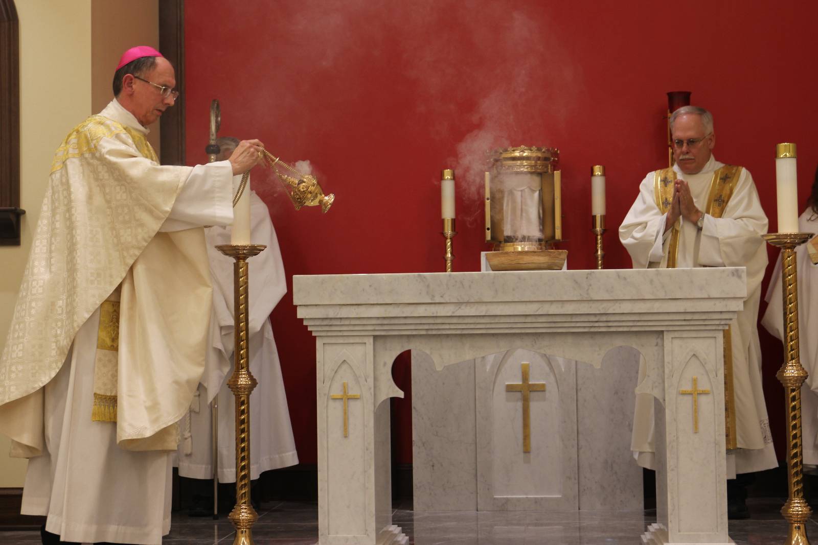 Incense is burned on the altar during the dedication rite, as Bishop Peter Jugis incenses the new altar at Holy Family Chapel Jan. 27.