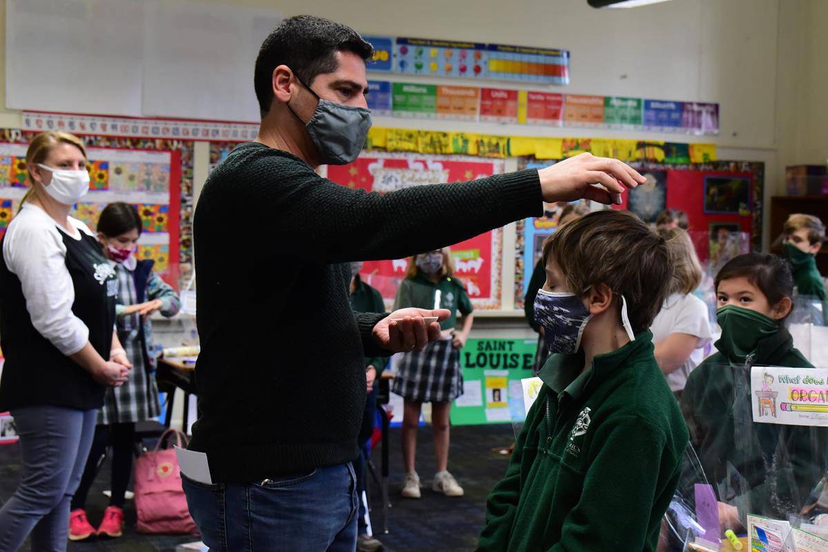 CHARLOTTE — Father Christopher Roux led an Ash Wednesday Liturgy of the Word over St. Patrick's School for students. Near the end of the liturgy, the teachers sprinkled ashes upon the heads of their students in each of the classrooms. (Photo via Facebook)