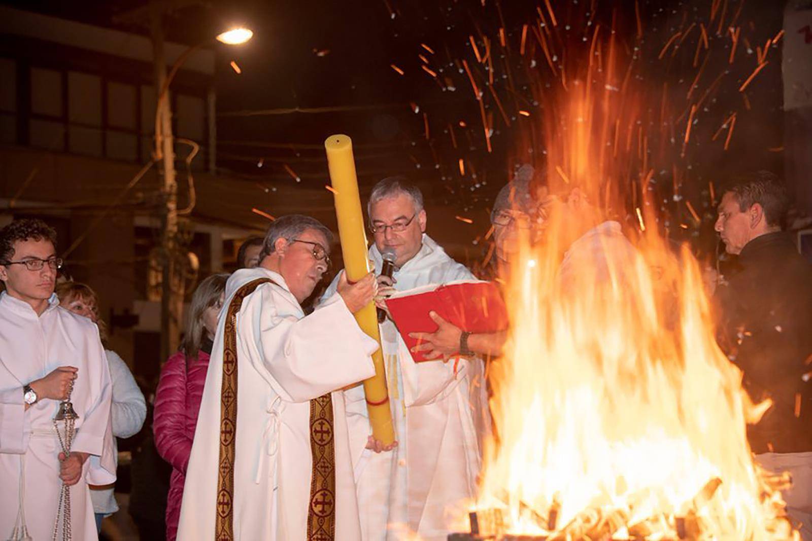 The Easter fire is blessed and the Paschal candle is lit during the Easter Vigil Mass at Our Lady of Mercy Church in Winston-Salem. (Photo via Facebook)
