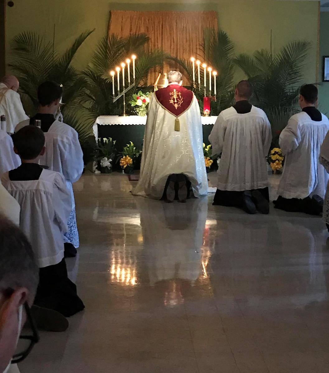 Clergy, servers and parishioners pray before the Blessed Sacrament on an altar of repose Holy Thursday at St. Michael Church in Gastonia. (Photo via Facebook)