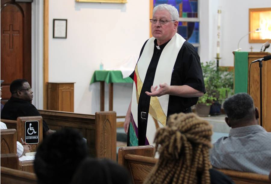 Father Carl Del Giudice, pastor, speaks at the start of a special prayer service at Our Lady of Consolation Church in Charlotte, following the death of 26-year-old parishioner Justin Carr