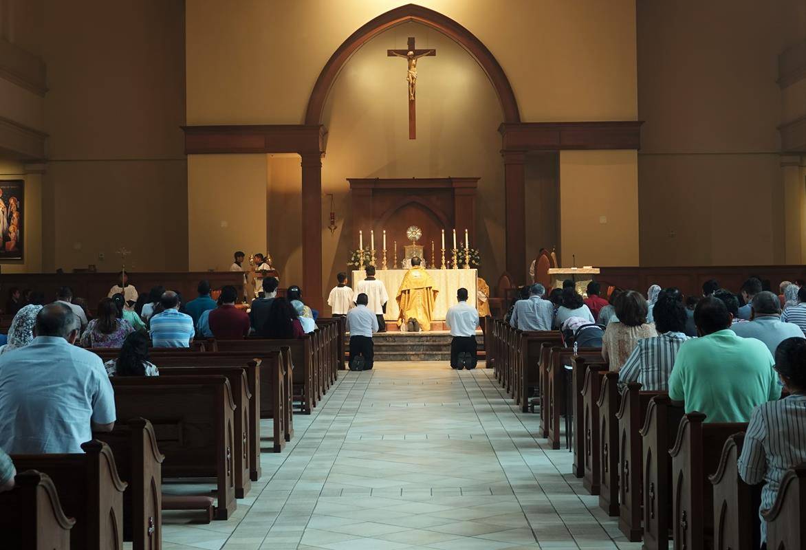 Parochial Vicar Fr. Alfonso Gámez carried the Blessed Sacrament through the church and outside into the grounds while the faithful followed.