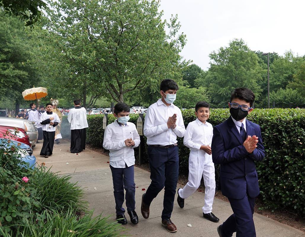 Both Eucharistic processions were led by our First Communicants who dropped rose petals along the sidewalks around the church.