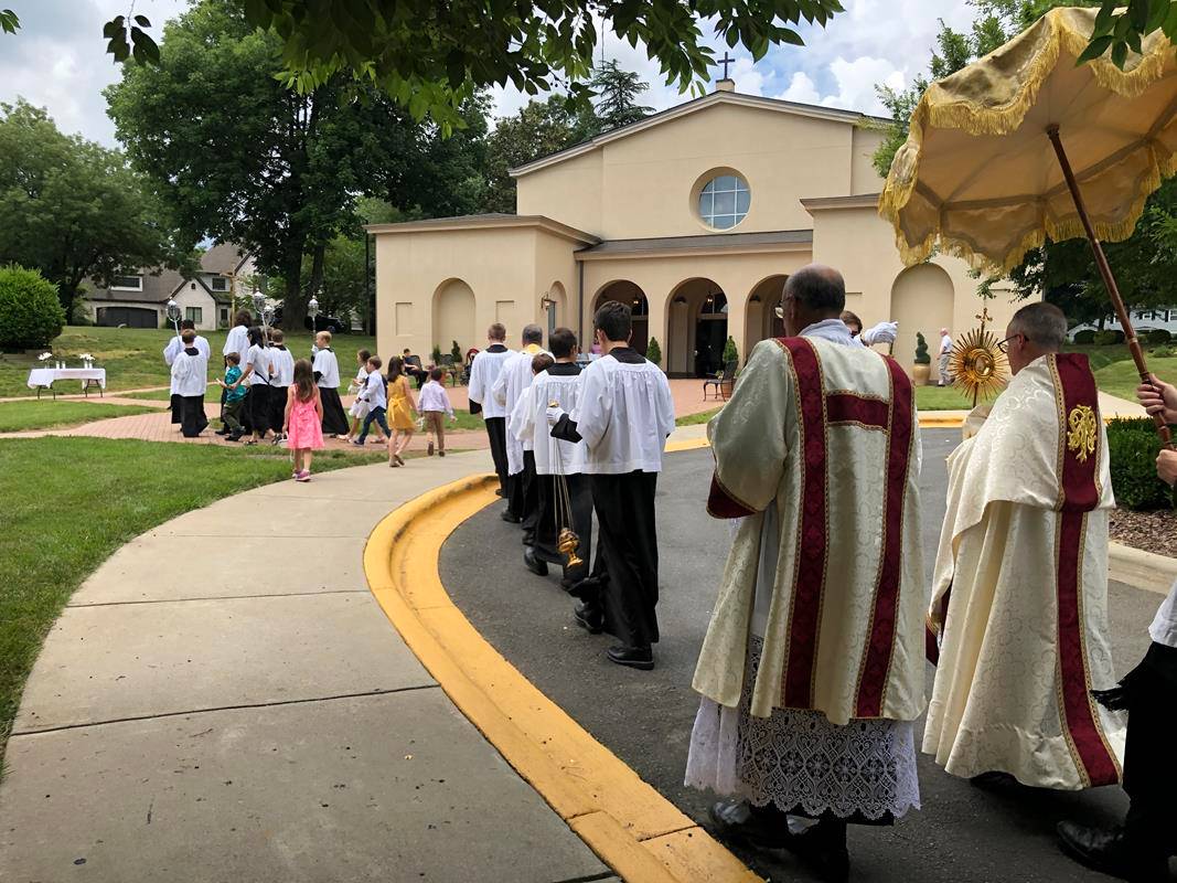 A Corpus Christi procession was held at St. Ann Church in Charlotte led by Father Timothy Reid. (Photos by SueAnn Howell)
