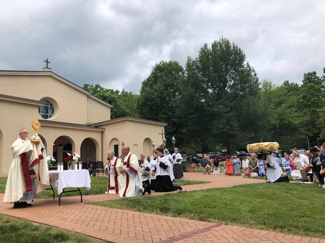 A Corpus Christi procession was held at St. Ann Church in Charlotte led by Father Timothy Reid. (Photos by SueAnn Howell)