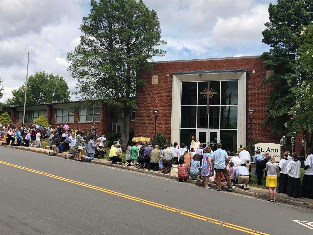 A Corpus Christi procession was held at St. Ann Church in Charlotte led by Father Timothy Reid. (Photos by SueAnn Howell)