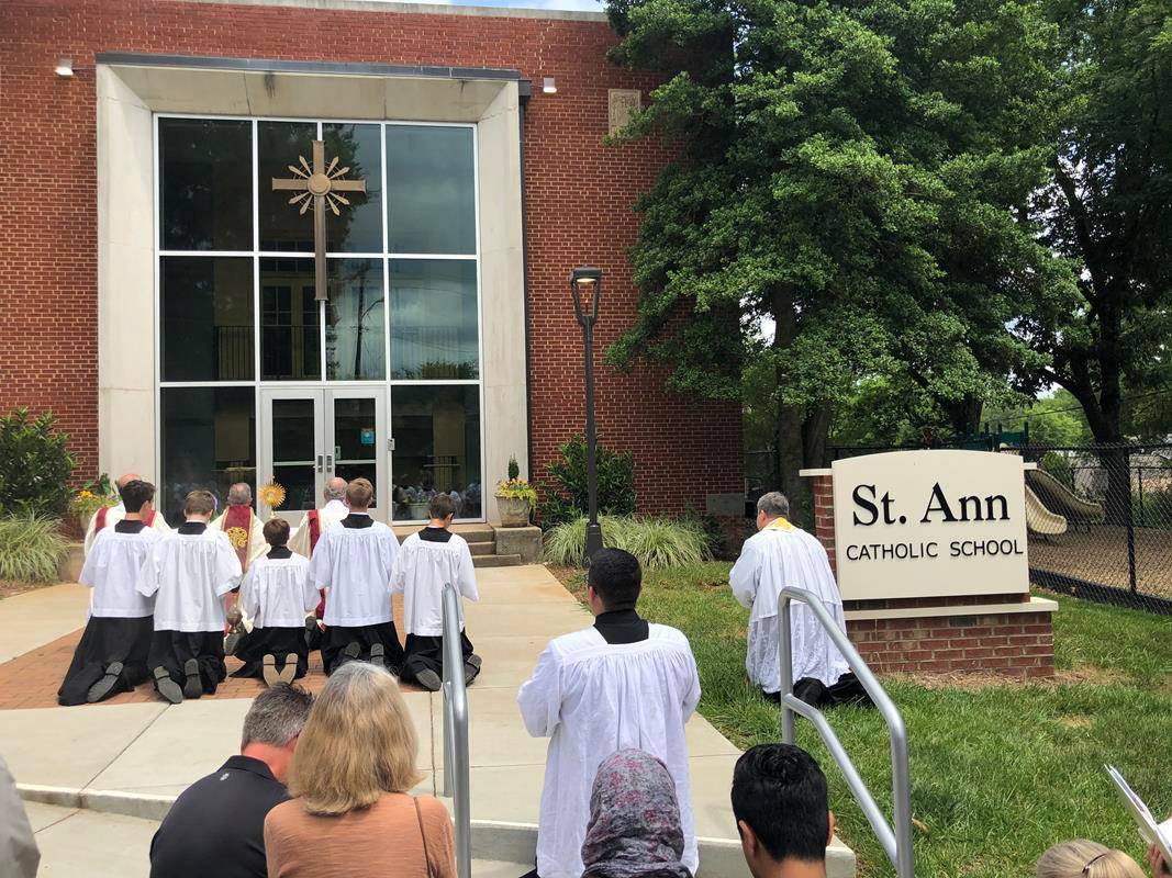A Corpus Christi procession was held at St. Ann Church in Charlotte led by Father Timothy Reid. (Photos by SueAnn Howell)