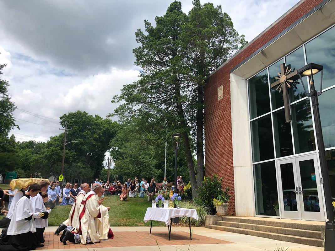 A Corpus Christi procession was held at St. Ann Church in Charlotte led by Father Timothy Reid. (Photos by SueAnn Howell)