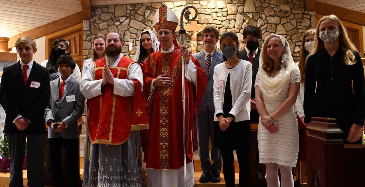 BOONE — Several of the youth of St. Elizabeth Church were confirmed by Bishop Peter Jugis on April 21. Confirmandi are pictured with the bishop and their pastor, Father Brendan Buckler. (Photo provided by Amber Mellon)