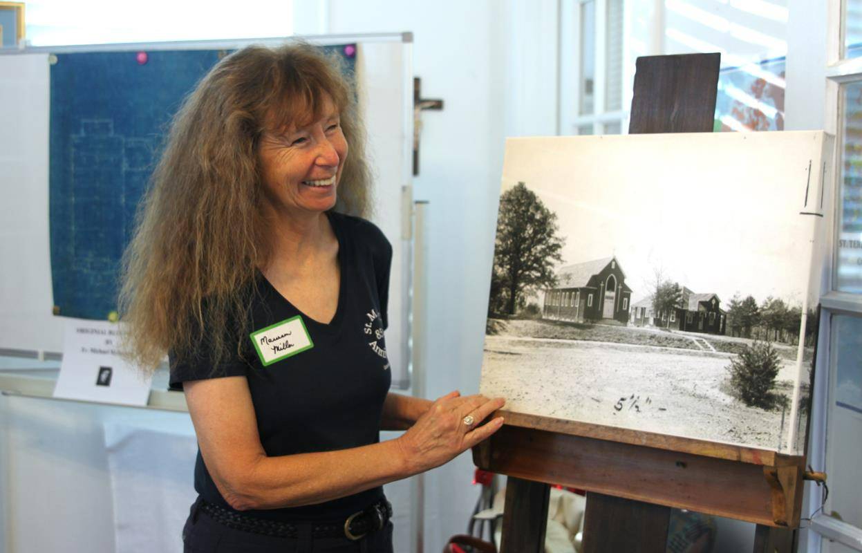 Parish archivist Maureen Miller worked for months to compile historical information and artifacts dating from the parish’s founding in 1936, the original blueprint drawn up by the famed church architect Benedictine Father Michael McInerney.