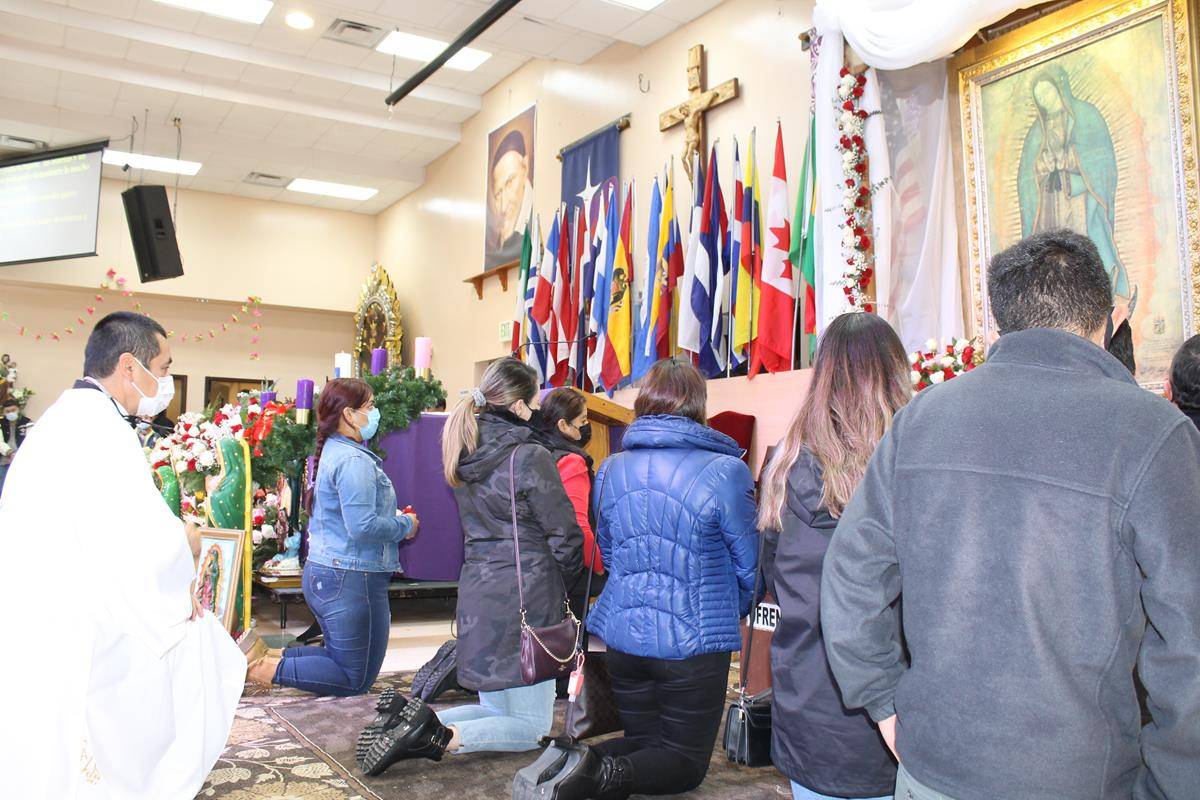 Parishioners kneel while praying for the intercession of Our Lady of Guadalupe during celebrations in Charlotte last weekend. (Photo by César Hurtado)