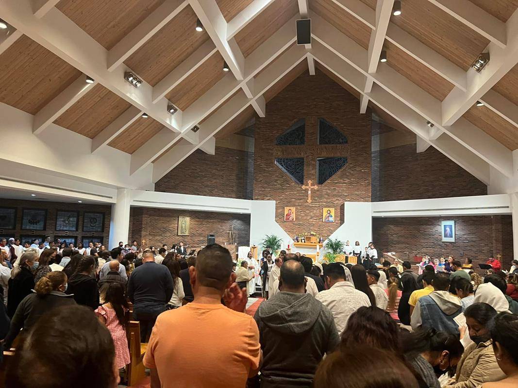 Lighting Candles and receiving Catechumen at a bilingual Mass at a Charlotte Myanmar Community Mass at Our Lady of Assumption in Charlotte. (Photo via Facebook).