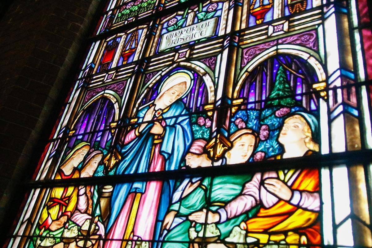 Just a fraction of the more than 30,000 pieces of stained glass imported from Belgium depict Our Lady in her title “Mirror of Justice.” 