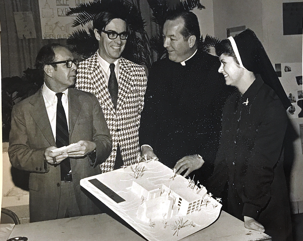 Father Francis Smith discusses plans for the new activity center with longtime parishioner and benefactor of Our Lady of Grace, the late Don Brady (second from left), and an Immaculate Heart of Mary sister.