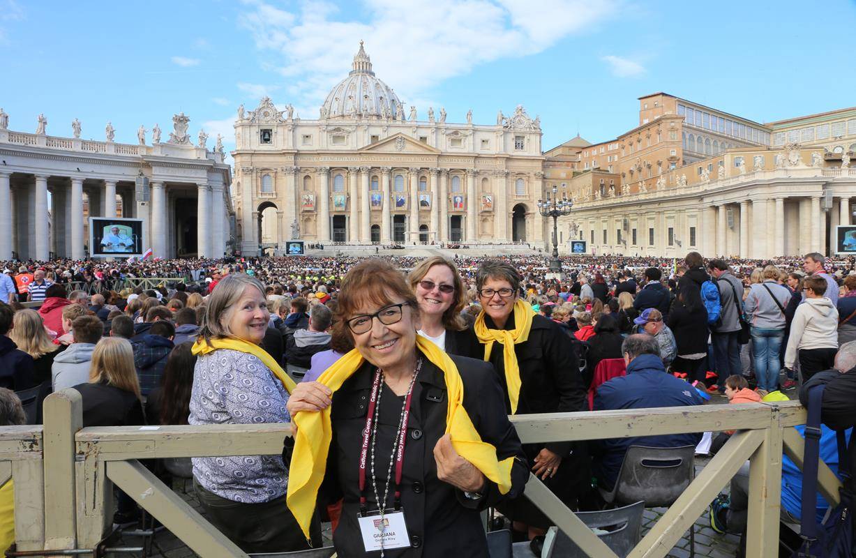 Pilgrims in St Peter's Square during Papal  Audience.See Pope Francis on video monitor  