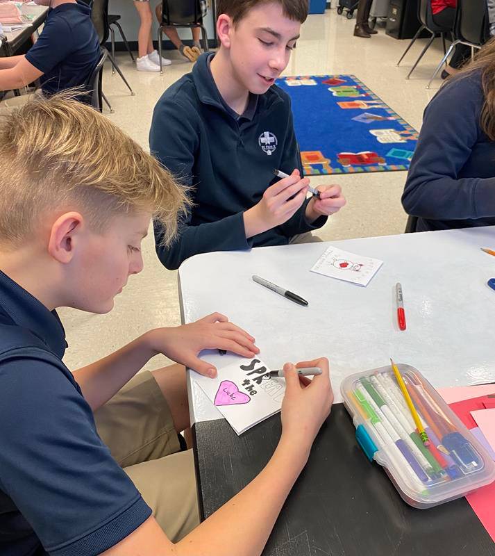 Greensboro’s St. Pius X eighth graders pose in the library with Superintendent Greg Monroe, Principal Chris Kloesz, and Instructional Assistant Kendra Winston.
