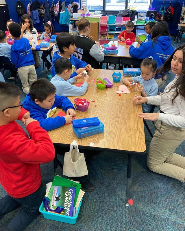 Our Lady of the Assumption School prayer partners in 7th and first grades work together on an art project to bring some cheer to the local community.