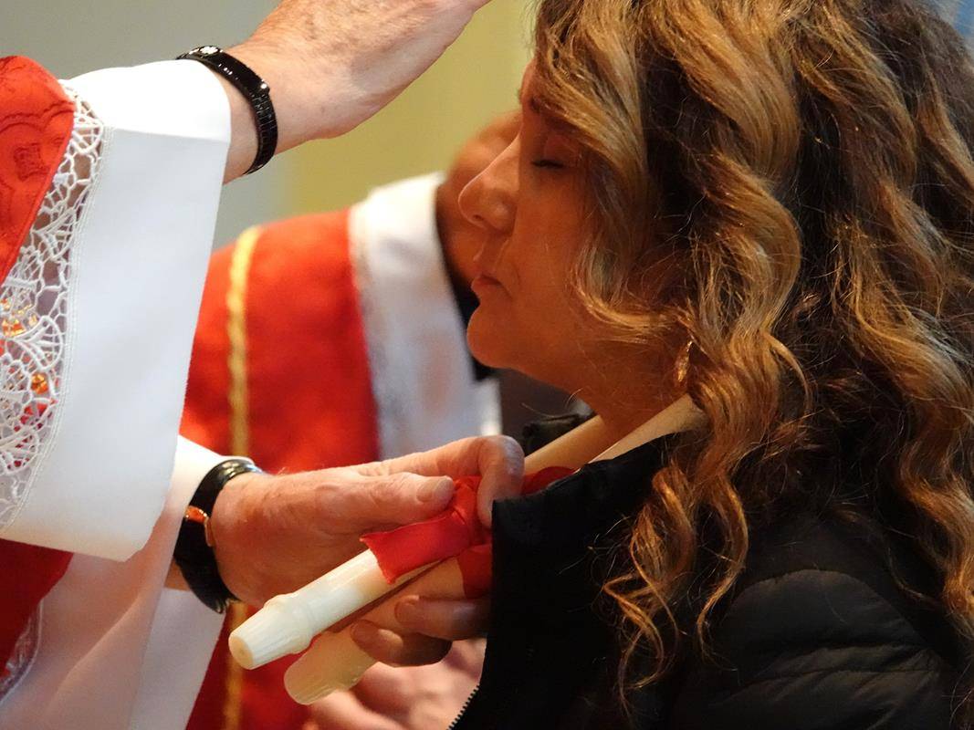 Father Melchesideck Yumo and Deacon Rich McCarron imparted the traditional throat blessing for the Feast Day of St. Blaise at the 9 a.m. Mass at St. Mark Church in Huntersville.