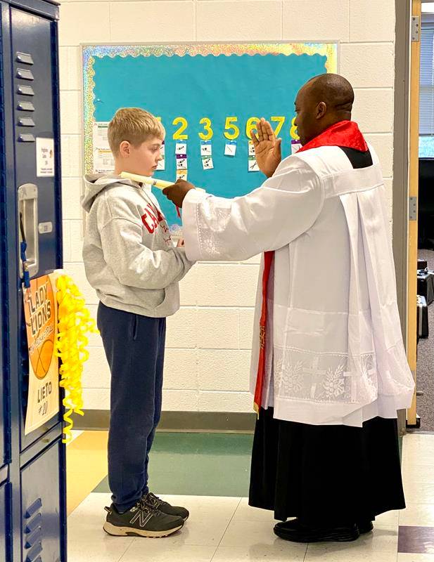 The middle school students were on their way to the annual Catholic Schools Week student volleyball games when they dress in team costumes—a great image of the intersection of faith and fun at Catholic schools in the diocese.