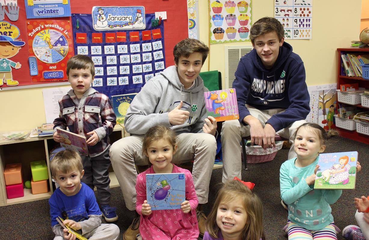 To kick off Catholic School's Week, Bishop McGuinness Catholic High School students served as alumni readers to their former Catholic elementary schools. Pictured are Zach Loncar and Matt Bruns at Saint Leo School in Winston Salem and Ryan Moon and David 