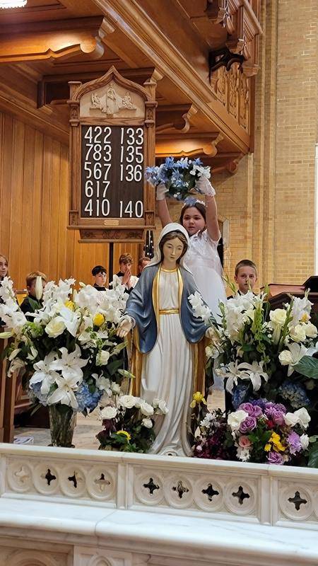 Our Lady of Grace School students celebrated second grade students who received their First Communion last weekend during their May 17 school Mass and crowned Mary. (Provided photos) 