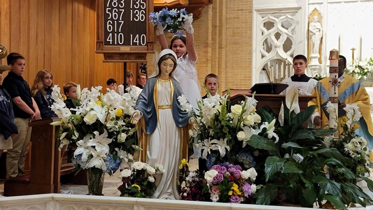 Our Lady of Grace School students celebrated second grade students who received their First Communion last weekend during their May 17 school Mass and crowned Mary. (Provided photos) 