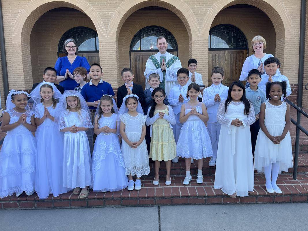 Second grade students at Sacred Heart School in Salisbury lead the all-school Mass and also adorned our Mother, Mary with flowers. (Provided photos) 