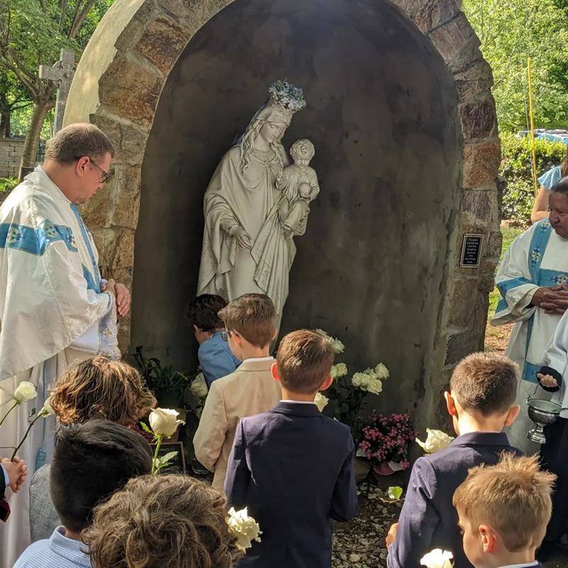 St. Patrick School students prayed at the grotto and the second graders crowned Mary and laid flowers at her feet. (Provided photos)
