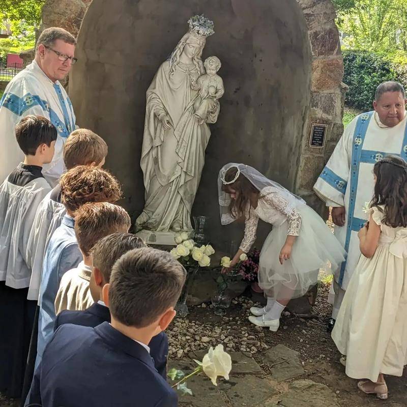 St. Patrick School students prayed at the grotto and the second graders crowned Mary and laid flowers at her feet. (Provided photos)