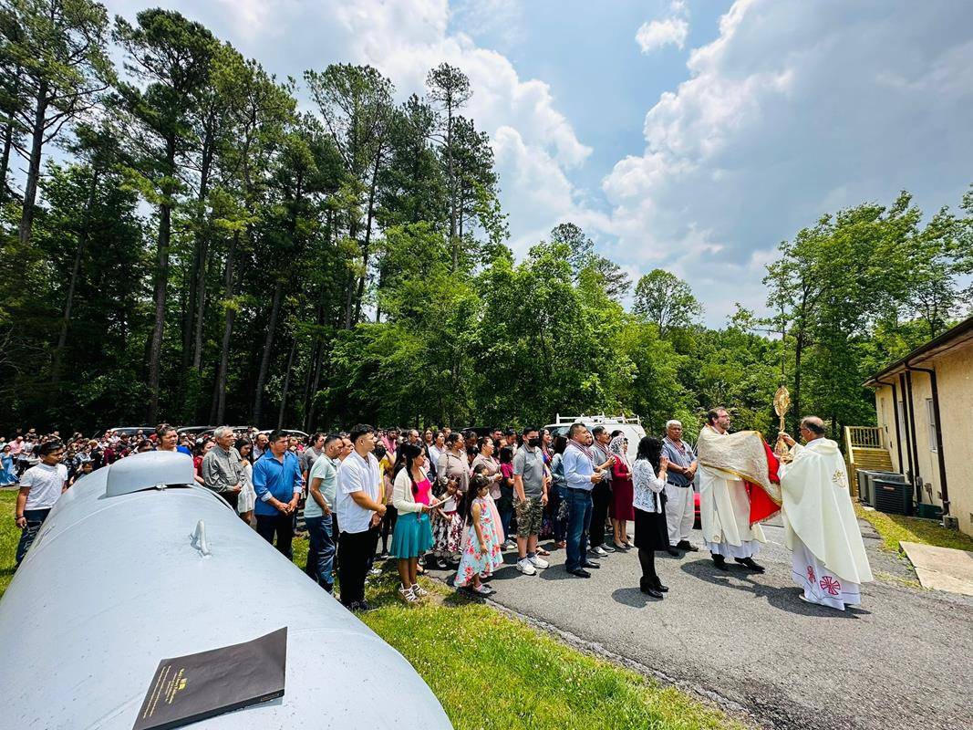 The faithful made colorful flower carpets to receive the Eucharist Procession at St Francis of Assisi in Franklin. They started working early in the morning.