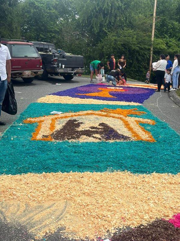 The faithful made colorful flower carpets to receive the Eucharist Procession at St Francis of Assisi in Franklin. They started working early in the morning.