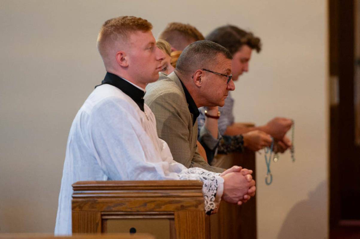 Peter Rusciolelli and his family pray during the Holy Hour at St. Patrick Cathedral Thursday.