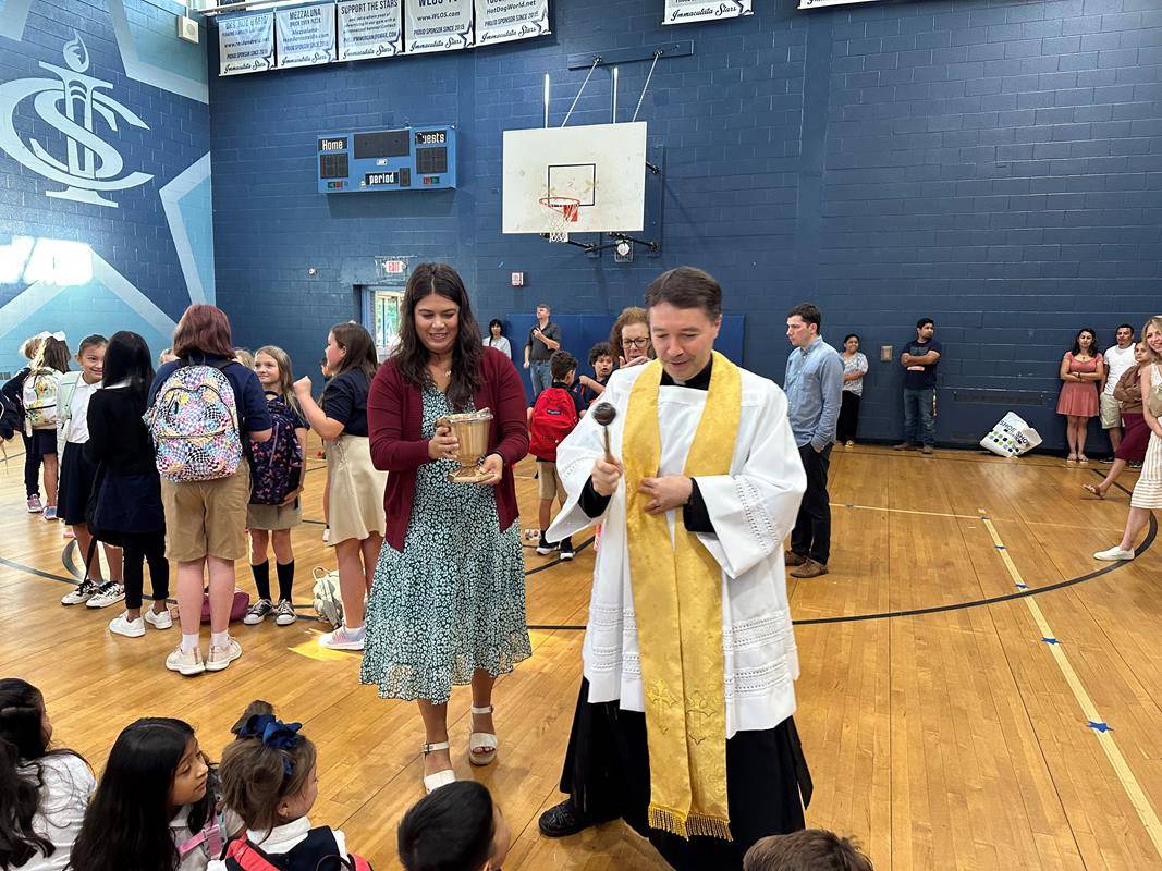 Holy Water on backpacks marked the start of the school year at Immaculata Catholic School .