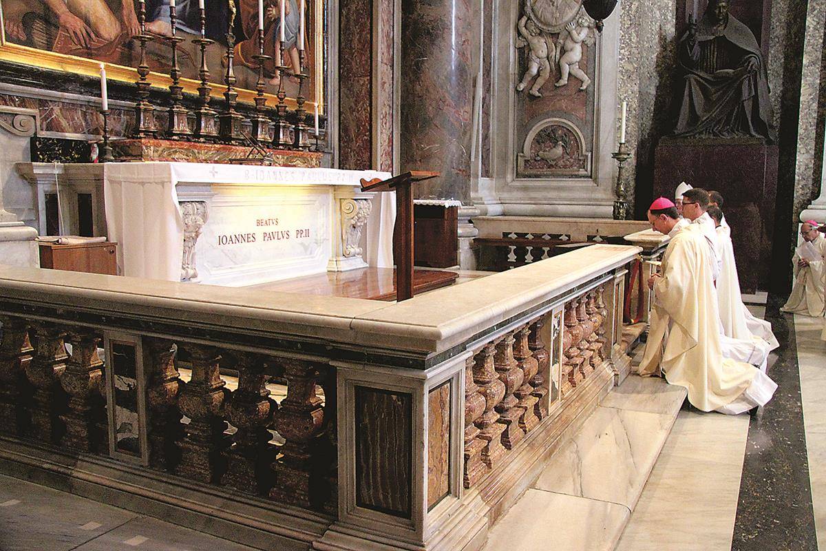 Bishop at tomb of Pope John Paul II who ordained him priest and bishop (Copy)