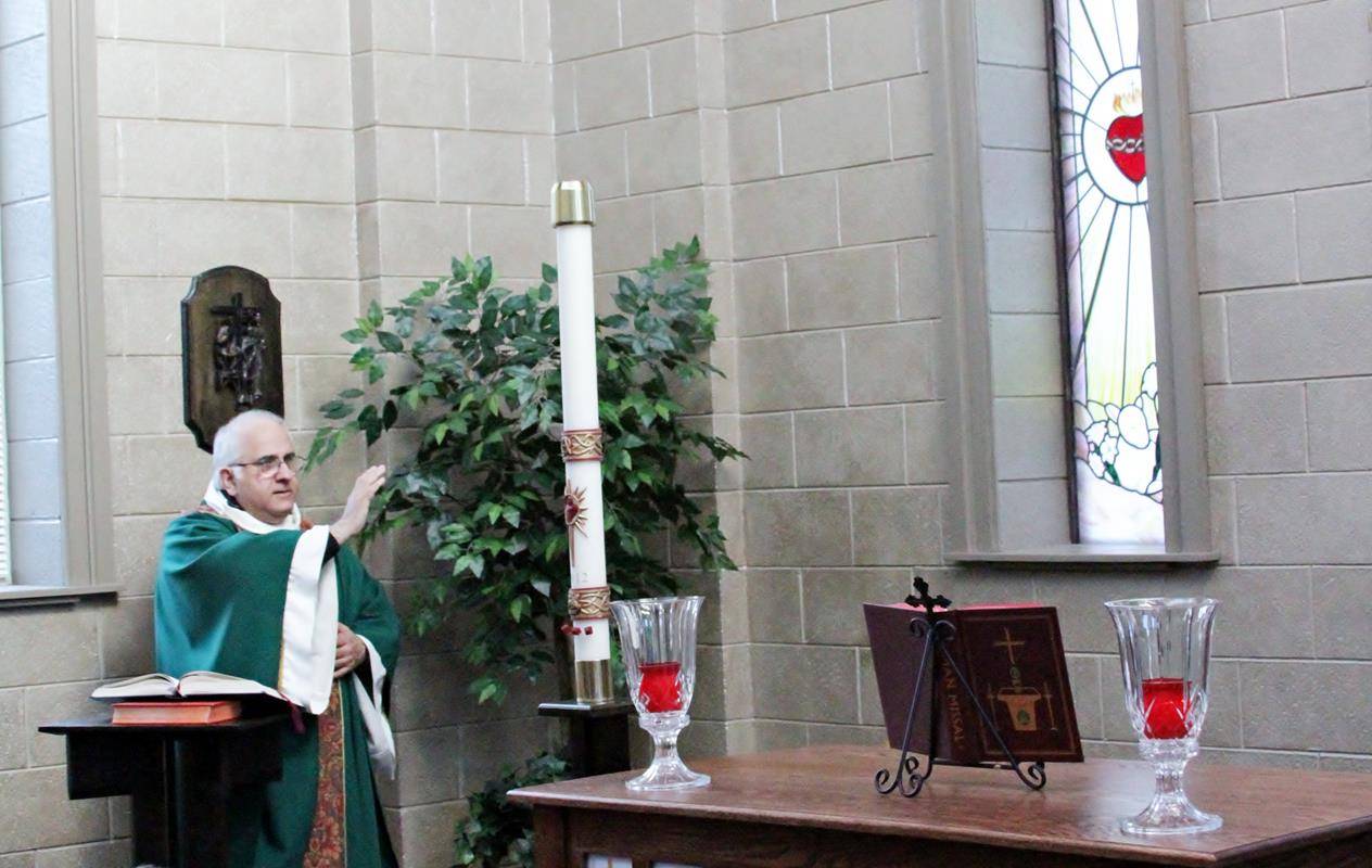 Msgr. Bellow blesses the new altar at St. Mark School's renovated chapel