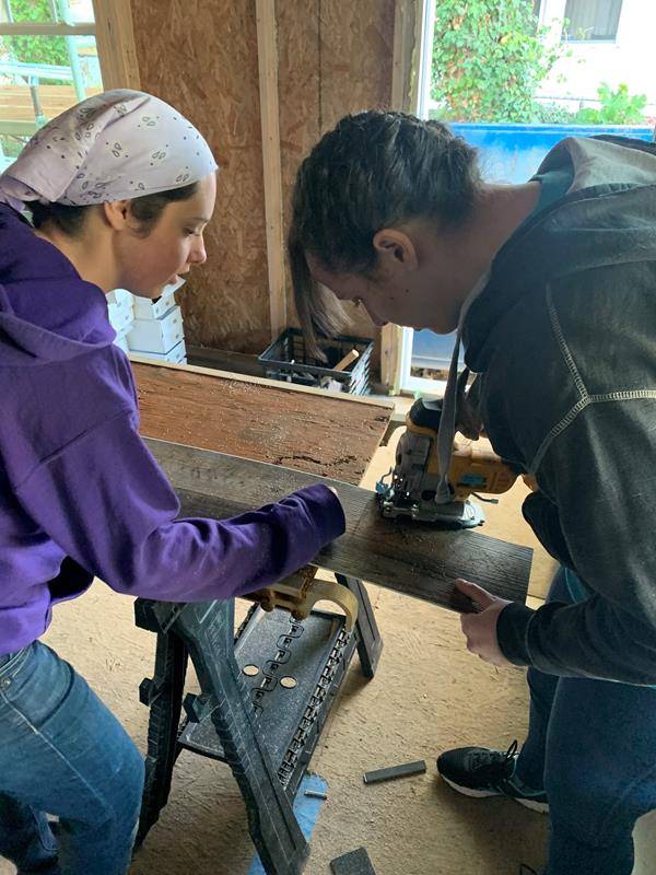 Winston Salem's Frassati young adult group volunteers to install flooring at a Habitat for Humanity home in eastern Winston-Salem.