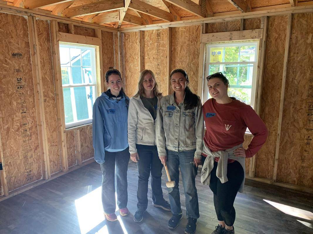 Winston Salem's Frassati young adult group volunteers to install flooring at a Habitat for Humanity home in eastern Winston-Salem.