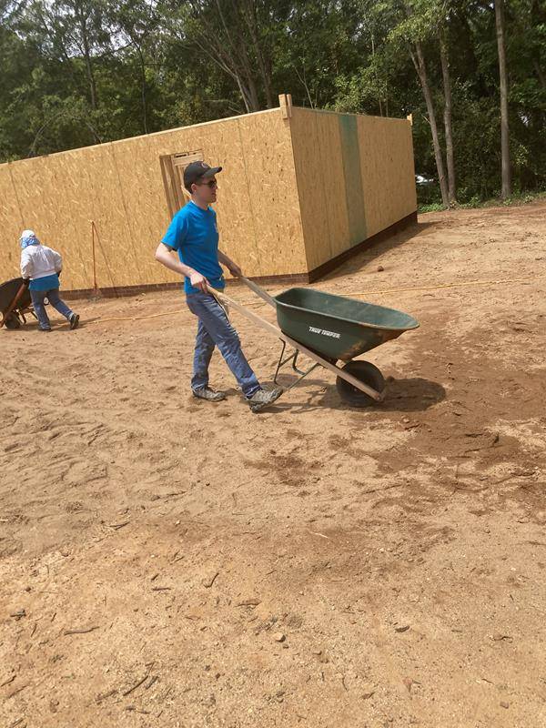 Father Peter Ascik helps at the build site.