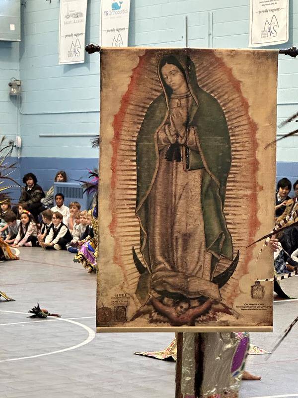 At Asheville Catholic School they celebrated the Feast of Our Lady of Guadalupe by by inviting the Aztec Dancers to perform. The performers include Latino community members as well as current and former ACS students.