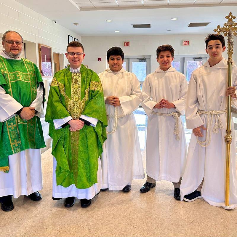 Deacon Mark Mejias (left) and altar servers assisted Father Brock at the Mass.