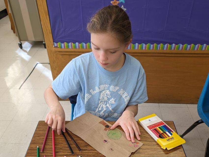 Service projects at Our Lady of Mercy included decorating bags for Meals on Wheels.