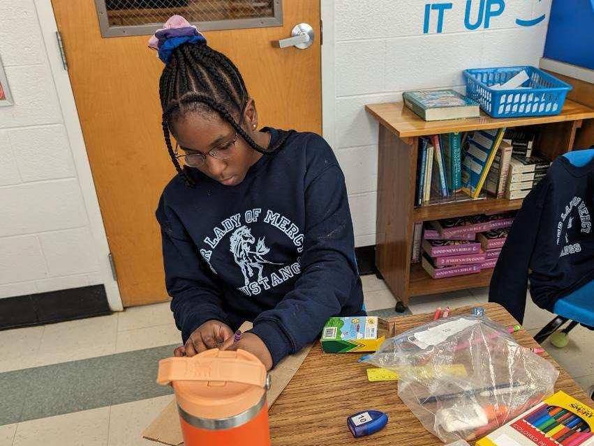 Service projects at Our Lady of Mercy included decorating bags for Meals on Wheels.
