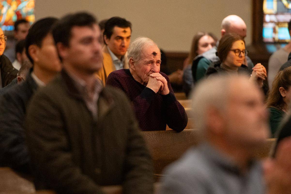 Faithful attend the 7:30 a.m. Ash Wednesday Mass at St. Peter Church in Charlotte. 