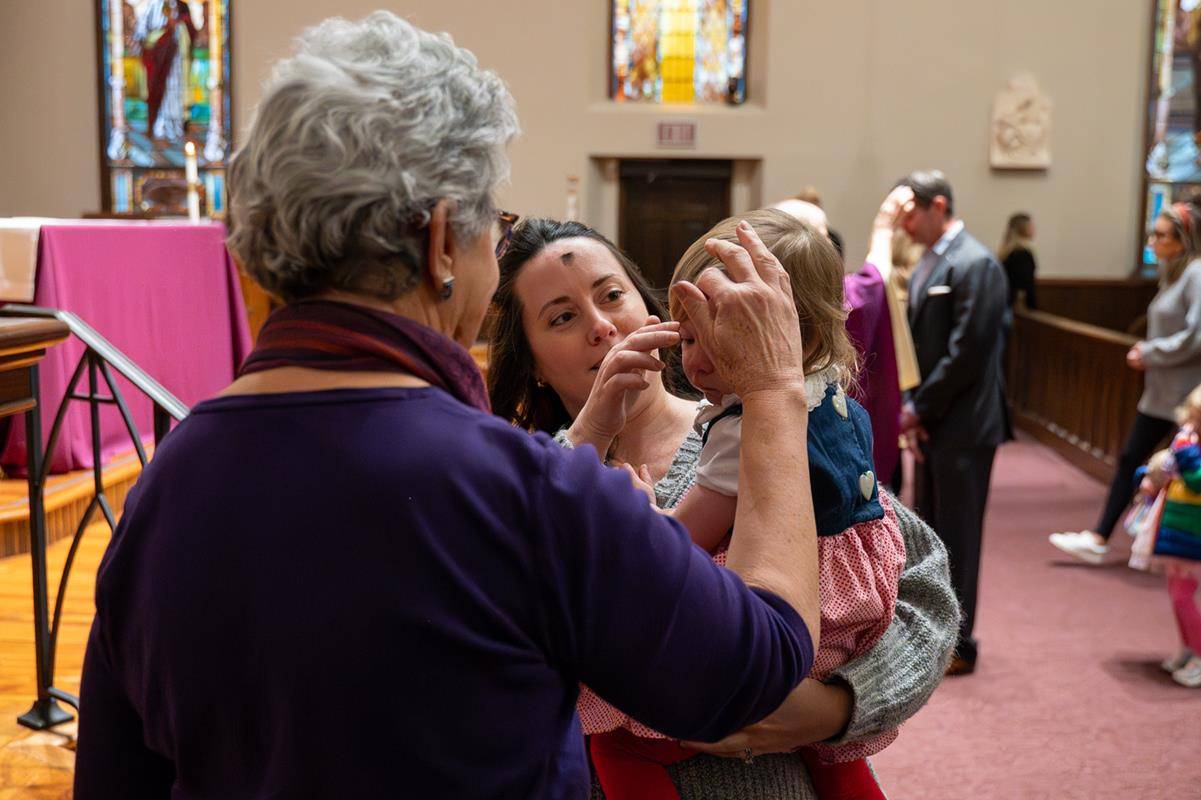 Faithful attend the 7:30 a.m. Ash Wednesday Mass at St. Peter Church in Charlotte. 