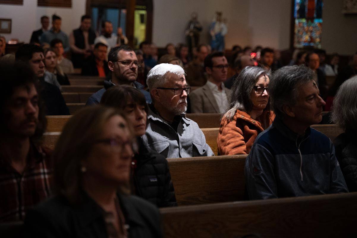 Faithful attend the 7:30 a.m. Ash Wednesday Mass at St. Peter Church in Charlotte. 